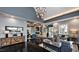 The open-concept space features dark, polished concrete floors, a stone fireplace and modern lighting fixtures at 109 Hiddenite Pl, Holly Springs, NC 27540