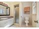 Bathroom with linoleum flooring, a vanity, wood cabinet, a toilet, and a standing shower with glass door at 1103 Driftwood Dr, Siler City, NC 27344