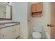 Bathroom featuring a vanity with a mirror, toilet, and cabinet for storage at 1103 Driftwood Dr, Siler City, NC 27344