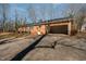 Exterior view of brick home with large driveway and attached carport for easy parking at 1103 Driftwood Dr, Siler City, NC 27344
