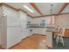 Well-equipped kitchen featuring white appliances, ample cabinet space, and a breakfast bar for casual dining at 1103 Driftwood Dr, Siler City, NC 27344