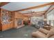 Inviting living room with a brick fireplace, exposed beams, and an open layout connecting to the kitchen at 1103 Driftwood Dr, Siler City, NC 27344