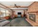 Cozy living room featuring a brick fireplace, exposed beams, and comfortable seating for relaxation at 1103 Driftwood Dr, Siler City, NC 27344