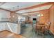 Inviting living space with a brick fireplace, dining area, and kitchen with a breakfast bar, perfect for entertaining at 1103 Driftwood Dr, Siler City, NC 27344