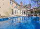 Beautiful backyard with a swimming pool and a covered seating area, perfect for outdoor relaxation at 112 Glenmore Rd, Cary, NC 27519