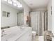 Well-lit bathroom with double sinks, a large mirror, and a shower-tub combination with a patterned curtain at 112 Glenmore Rd, Cary, NC 27519