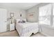 Cozy bedroom features a white metal bed frame, soft carpet, and a window with natural light at 112 Glenmore Rd, Cary, NC 27519