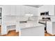 Bright kitchen featuring white cabinets, quartz countertops and stainless steel appliances at 112 Glenmore Rd, Cary, NC 27519