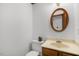 Bathroom featuring a wood cabinet, oval mirror, and decorative succulent at 112 Ridgepath Way, Cary, NC 27511