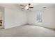 Bedroom with vaulted ceilings, a ceiling fan, and a large window at 112 Ridgepath Way, Cary, NC 27511