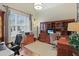 Spacious home office with custom wooden cabinetry, a desk area, and a comfortable workspace at 113 Hardy Oaks Way, Holly Springs, NC 27540