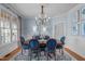 Elegant dining room with a classic chandelier and comfortable seating at 114 Lansbrooke Ln, Apex, NC 27502