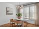 Elegant dining room features natural light, modern lighting, and seating for four around a stone-topped table at 114 Lansbrooke Ln, Apex, NC 27502