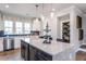 Contemporary kitchen with an island and stainless steel appliances, complemented by an adjacent half bath at 1176 Holding Village Way, Wake Forest, NC 27587