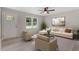 Inviting living room with neutral walls, light wood floors, cream-colored furniture, and a ceiling fan at 1211 Freeman Dr, Sanford, NC 27330