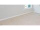 Neutral carpeted bedroom features a window and white trim at 132 Ambergate Ct, Rocky Mount, NC 27804