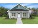 Charming single-story home with blue accents, a well-manicured lawn, and a welcoming front porch at 132 Ambergate Ct, Rocky Mount, NC 27804