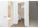 Hallway view of full bathroom, leading to bedrooms with hardwood flooring and carpet at 132 Ambergate Ct, Rocky Mount, NC 27804
