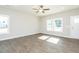 Bright living room with hardwood floors, large windows, and a ceiling fan at 132 Ambergate Ct, Rocky Mount, NC 27804