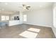 Open living space with hardwood floors connecting to a modern kitchen with a bar and stainless steel appliances at 132 Ambergate Ct, Rocky Mount, NC 27804