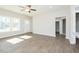 Well-lit living room with hardwood floors, large windows, and a view of the entry door and kitchen at 132 Ambergate Ct, Rocky Mount, NC 27804