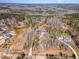 Aerial view showcases a wooded lot with manicured landscaping and circular driveway at 148 Evington Dr, Pittsboro, NC 27312