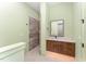 Bathroom with walk-in shower, sleek vanity, and modern fixtures at 148 Evington Dr, Pittsboro, NC 27312