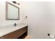 Clean bathroom with a modern vanity, quartz countertop, and dark fixtures at 148 Evington Dr, Pittsboro, NC 27312