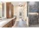 Modern bathroom with double vanity, walk-in shower, and stylish lighting fixtures at 148 Evington Dr, Pittsboro, NC 27312