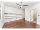 Large bedroom featuring beautiful floors, a ceiling fan, and built in shelving at 148 Evington Dr, Pittsboro, NC 27312
