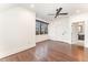 Bright bedroom with hardwood floors, ceiling fan, and windows offering a scenic outdoor view at 148 Evington Dr, Pittsboro, NC 27312