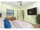 Bright bedroom with a neutral color scheme, sleek furniture, and a mounted TV for modern comfort at 148 Evington Dr, Pittsboro, NC 27312