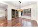 Sunlit dining room featuring wood floors, modern light fixture, and glass sliding door with beautiful view at 148 Evington Dr, Pittsboro, NC 27312