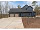 Contemporary navy home boasts a 3-car garage, well-manicured landscaping, and neutral trim at 148 Evington Dr, Pittsboro, NC 27312