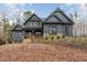 Stunning two-story home featuring stone accents, a covered porch, and professional landscaping at 148 Evington Dr, Pittsboro, NC 27312