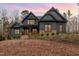 Two-story home featuring stone accents, a covered porch, and professional landscaping at sunset at 148 Evington Dr, Pittsboro, NC 27312
