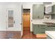 Modern kitchen with stainless appliances, green cabinetry, and an adjacent elevator to provide accessibility at 148 Evington Dr, Pittsboro, NC 27312