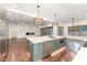 Open kitchen with a center island, stainless steel appliances, and seamless transition to the living area at 148 Evington Dr, Pittsboro, NC 27312