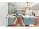 Stylish kitchen showcasing custom green cabinets, stainless steel appliances, and a spacious center island at 148 Evington Dr, Pittsboro, NC 27312