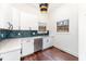 Stylish kitchenette with white cabinetry, blue backsplash, and modern appliances at 148 Evington Dr, Pittsboro, NC 27312