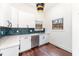 Stylish kitchenette features white cabinets, stainless steel appliances, and a herringbone backsplash at 148 Evington Dr, Pittsboro, NC 27312