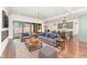 Open-concept living room with hardwood floors, modern decor, and a seamless transition to the outdoor patio at 148 Evington Dr, Pittsboro, NC 27312