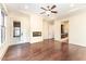 Bright living room featuring hardwood floors, modern fireplace, and access to the outdoor deck at 148 Evington Dr, Pittsboro, NC 27312