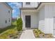 Inviting front entrance with a modern black door and well-maintained landscaping at 1509 Rhodes Pond St, Wendell, NC 27591