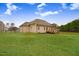 Serene backyard with lush green grass and a charming brick home under a bright sky at 151 Becky Ln, Princeton, NC 27569