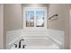 Modern bathroom with tiled soaking tub under a window at 151 Becky Ln, Princeton, NC 27569