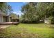 Expansive backyard featuring a wooden deck, lush lawn, mature trees, privacy fence, and a storage shed at 1512 Maybrook Dr, Raleigh, NC 27610