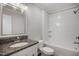 Renovated bathroom showcases granite countertops and a fully tiled tub-shower with sleek white finishes at 1512 Maybrook Dr, Raleigh, NC 27610