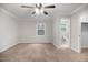 Spacious bedroom featuring neutral carpeting, a ceiling fan, and an ensuite bathroom at 1512 Maybrook Dr, Raleigh, NC 27610
