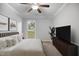 Inviting bedroom showcasing a large bed, neutral tones, and a window overlooking the outdoors at 1512 Maybrook Dr, Raleigh, NC 27610
